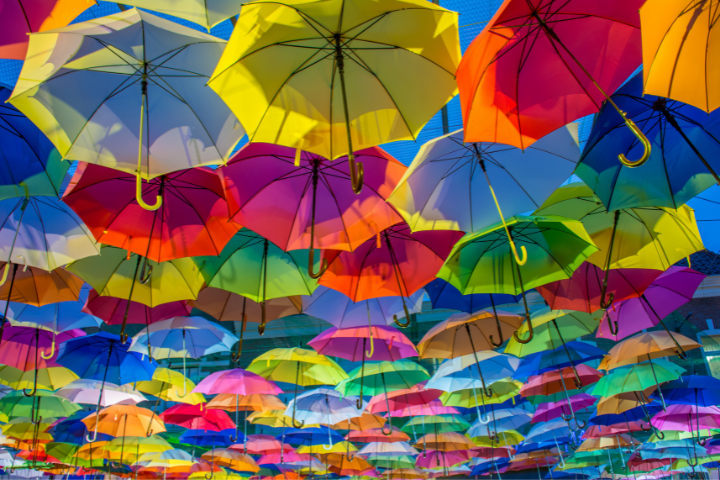 Increase revenue by marketing to your existing clients - colourful umbrellas making a cloud cover