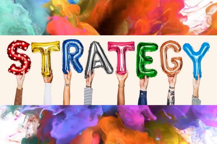 Things to consider when writing an integrated marketing strategy - the word strategy spelled out in foil helium balloons in different colours held up by hands.
