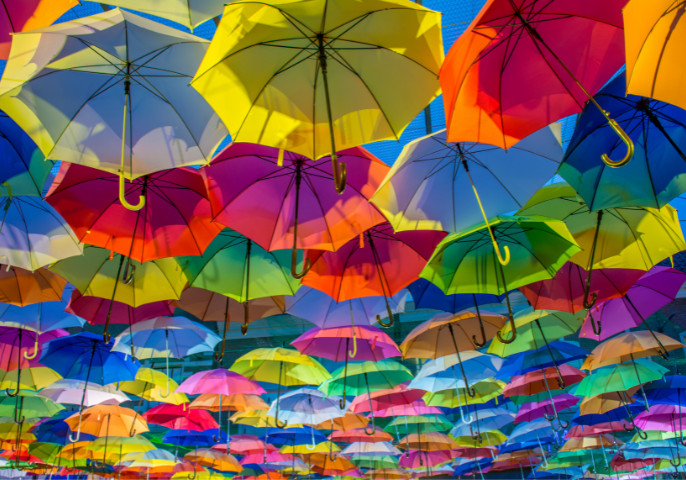 Increase revenue by marketing to your existing clients - colourful umbrellas making a cloud cover