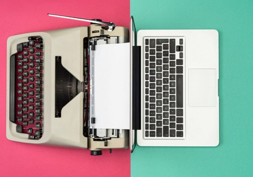 a typewriter with a pink and green division showing pr vs digital pr